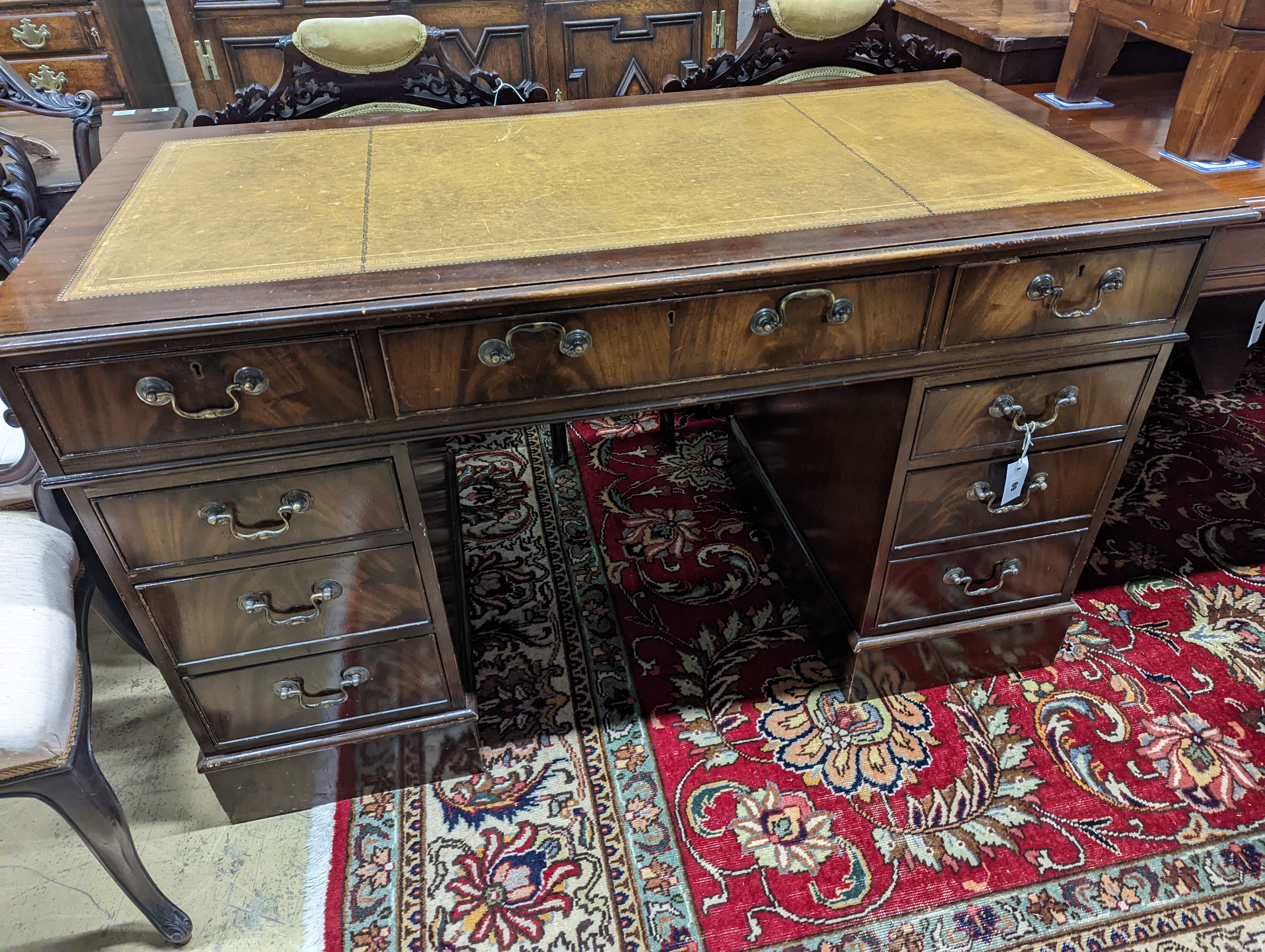 A reproduction mahogany pedestal desk, length 138cm, depth 69cm, height 79cm